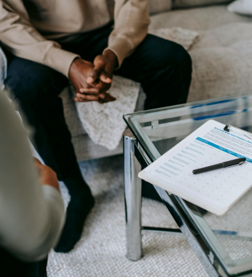 person in session with paperwork on the table