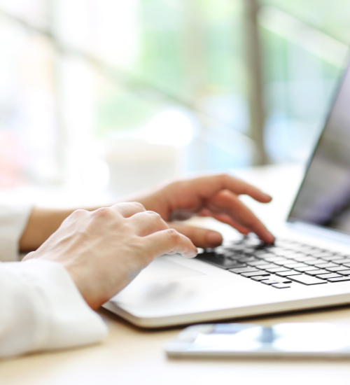 persons hands on laptop
